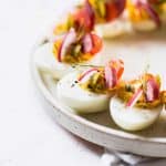 These FULLY LOADED KETO DEVILED EGGS are the perfect twist on the classic deviled eggs. The perfect bite of savory, pickled, sweet and smokey. #deviledeggs #keto #lowcarb #eggs #appetizer