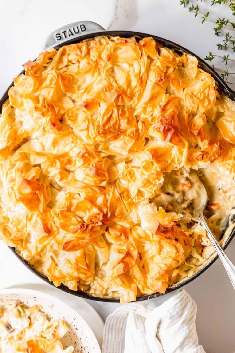 a spoon taking a scoop out of a mushroom chicken pot pie.