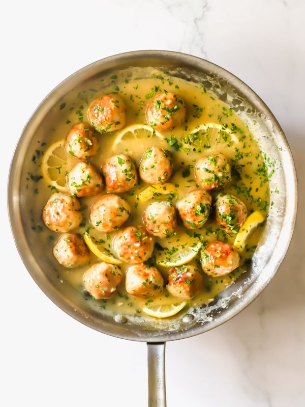 Chicken piccata meatballs in a pan.