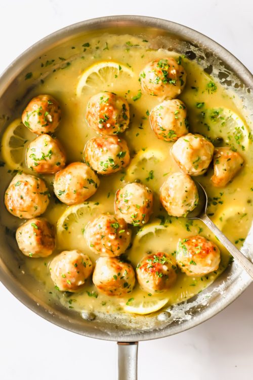 Chicken piccata meatballs in a pan.