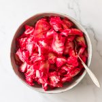 Pickled cabbage with beets in a bowl.