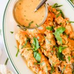 Baked chicken kabobs on a plate.