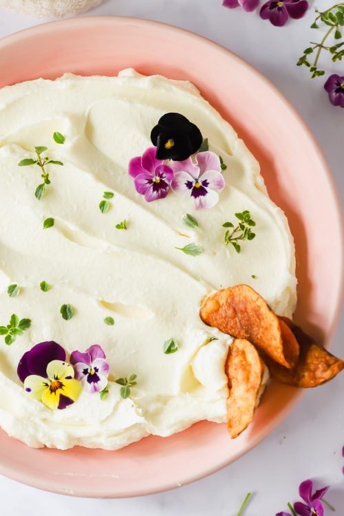 Chips dipping into a bowl of Brie.