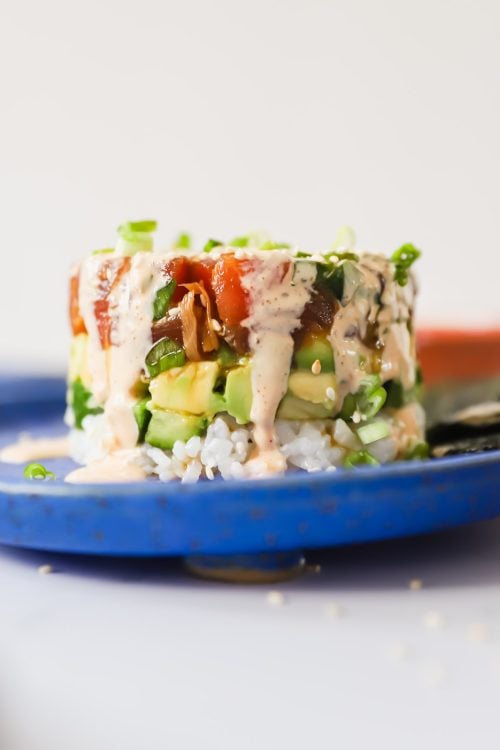 Spicy mayo covering a stack of tuna and rice.