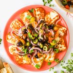 Fried halloumi and tomato salad on a plate.
