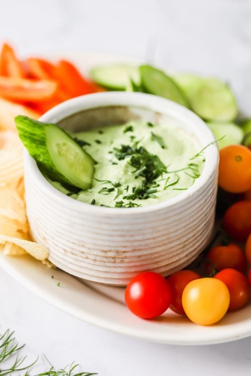 Cucumber dipped into cottage cheese dip.