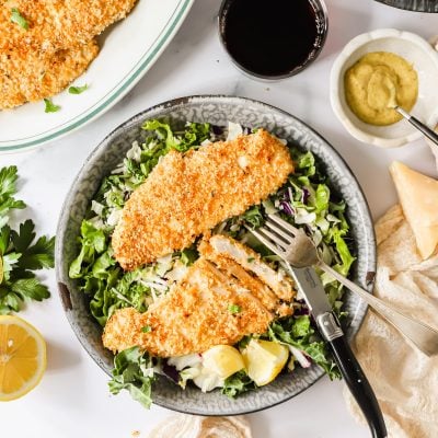 Panko chicken on a bed of greens.