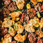 Smashed fingerling potatoes on a baking sheet.