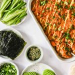 Casserole dish full of a salmon sushi bake.