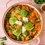 Baked creamy chicken enchiladas with toppings.