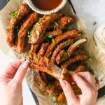 Hands holding a rib.