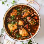 A pot with chicken in wine sauce.