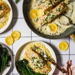 Serving salmon on a plate with garnishes.