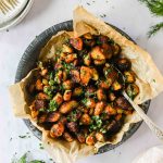 Overhead shot of crispy roast potatoes served on a parchment paper-lined dish