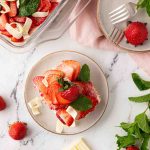 Overhead shot of a plate with a piece of homemade strawberry tiramisu.