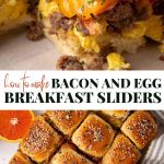 Close-up of bacon, egg, and sausage breakfast sliders on a baking sheet, topped with sesame seeds. A hand is pulling one slider apart from a batch.