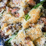 A plate of steak Caesar salad topped with grilled steak slices, grated cheese, and breadcrumbs, labeled as "Easy Steak Caesar Salad" from LenasKitchenBlog.com.